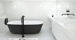 Black bathtub faucets in the interior photo