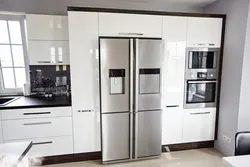 Free-standing refrigerator in the interior of the kitchen living room