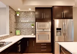 Free-standing refrigerator in the interior of the kitchen living room
