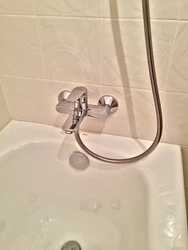 Location of the faucet in the bathroom photo