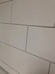Grout for gray tiles in the bathroom photo