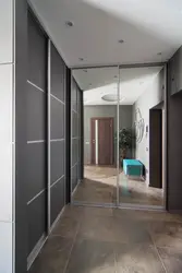 Photo of a hallway with a wardrobe in a modern style, narrow and long