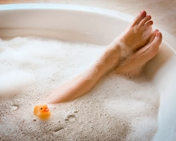 Photo of a bathtub with foam and legs