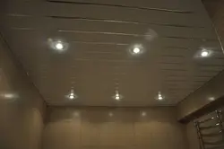 Bathroom ceiling made of plastic panels with spotlights photo