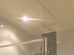 Bathroom ceiling made of plastic panels with spotlights photo