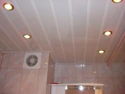 Bathroom ceiling made of plastic panels with spotlights photo