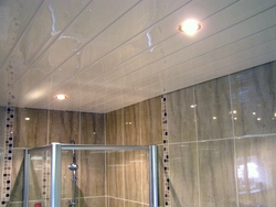 Bathroom ceiling made of plastic panels with spotlights photo