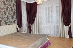 Velvet curtains in the bedroom interior photo