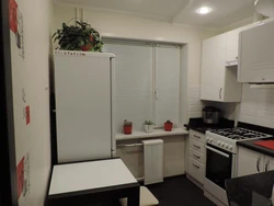 Small Kitchen With Refrigerator And Table Photo