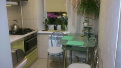 Small kitchen with refrigerator and table photo