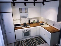 Small kitchen with refrigerator and table photo
