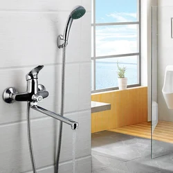 Photo of a faucet in a bathroom with a shower