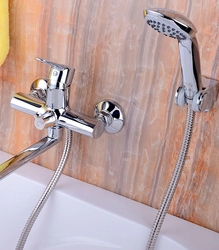 Photo of a faucet in a bathroom with a shower