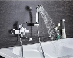 Photo of a faucet in a bathroom with a shower