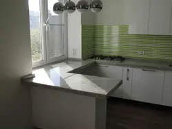 Instead of a window sill there is a countertop in the kitchen in Khrushchev photo
