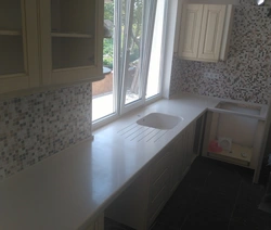 Instead of a window sill there is a countertop in the kitchen in Khrushchev photo