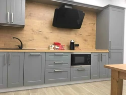 Gray kitchen with wooden facades photo