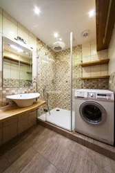 Bathroom interior with shower and washing machine