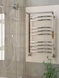 Electric heated towel rail in the bathroom interior photo