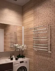 Electric heated towel rail in the bathroom interior photo