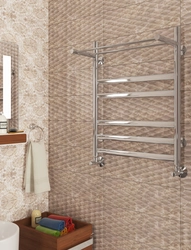 Electric heated towel rail in the bathroom interior photo
