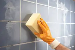 Grouting tiles in the bathroom photo