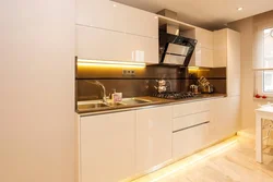 Beige kitchen design with black splashback