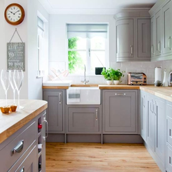 Gray kitchen with wooden countertop in the interior of the kitchen living room