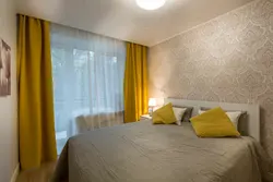 Yellow curtains in the bedroom interior photo