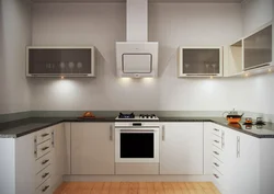 White kitchen design with black appliances