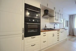 White Kitchen Design With Black Appliances