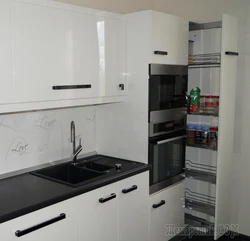 White kitchen design with black appliances