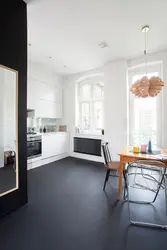 Dark floors and light walls in the kitchen interior