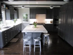 Dark floors and light walls in the kitchen interior