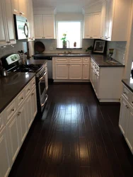 Dark Floors And Light Walls In The Kitchen Interior