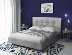 Gray soft bed in the bedroom interior