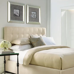 Gray soft bed in the bedroom interior
