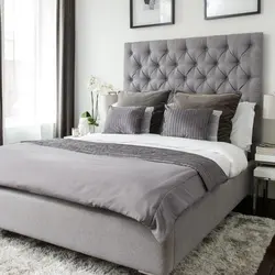 Gray soft bed in the bedroom interior