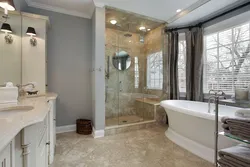 Photo of a bathroom with a toilet and a shower corner