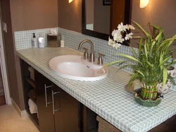 Tile countertop in the bathroom under the sink photo