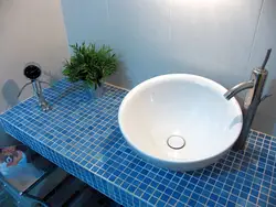 Tile countertop in the bathroom under the sink photo