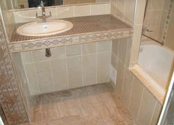 Tile countertop in the bathroom under the sink photo