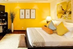 Bedroom with yellow wallpaper photo