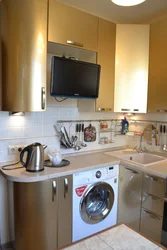 Photo of a kitchen with a refrigerator, washing machine and gas stove