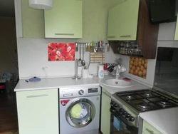 Photo of a kitchen with a refrigerator, washing machine and gas stove