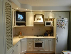 Corner kitchen design with refrigerator and TV photo