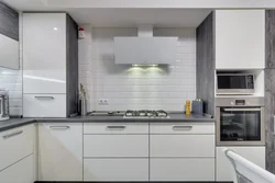 Kitchen with white appliances in the interior photo