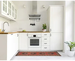 Kitchen with white appliances in the interior photo