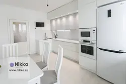 Kitchen with white appliances in the interior photo