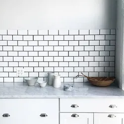 Photo of white tiles with black grout in the bathroom